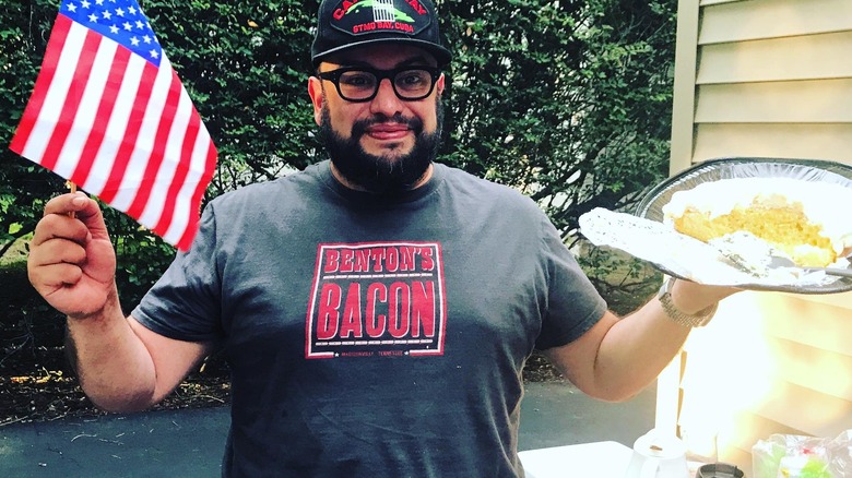 Carl Ruiz holding tiny American flag and cake 