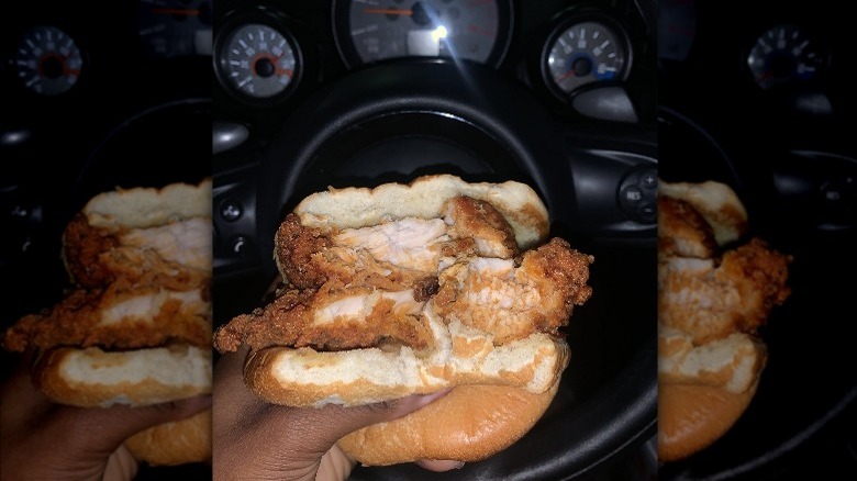 Hand holding Chick-fil-A double chicken sandwich