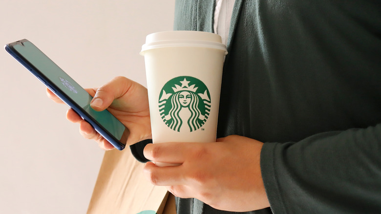 Phone and white Starbucks cup