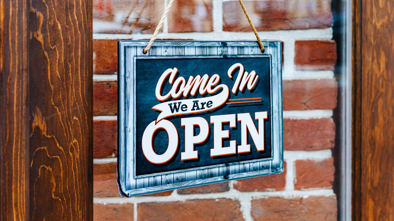 open sign on front door of business