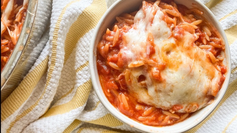 Bowl of orzo with tomatoes and melted mozzarella