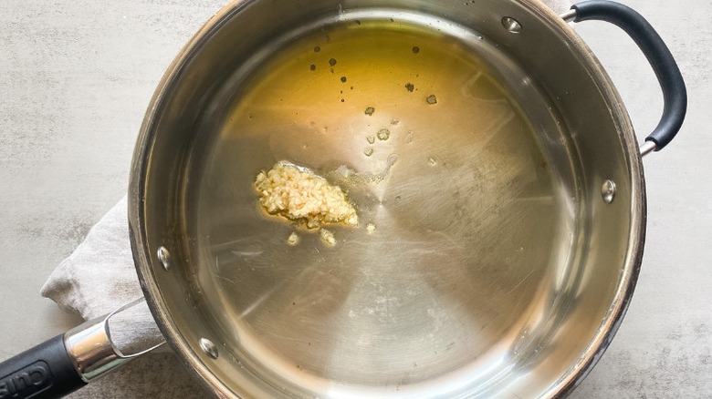 Minced garlic and oil cooking in a pot