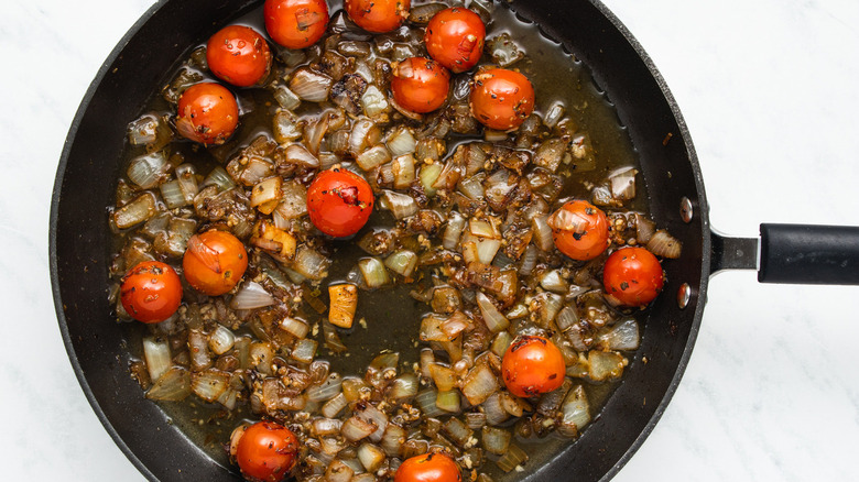 onions and tomatoes in pan