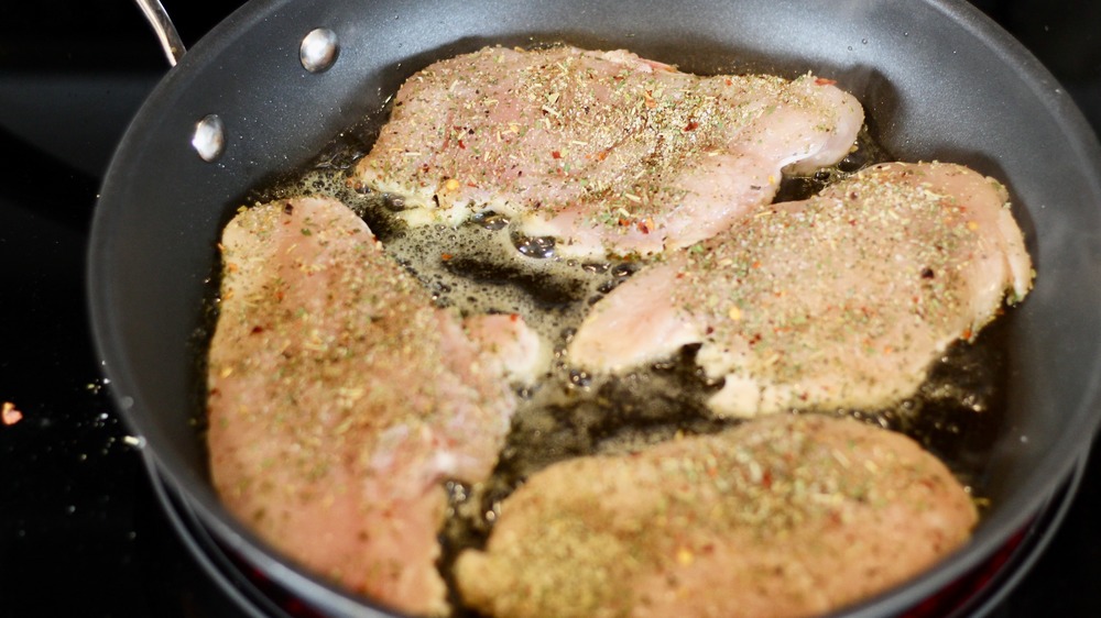 Searing chicken breasts in a pan