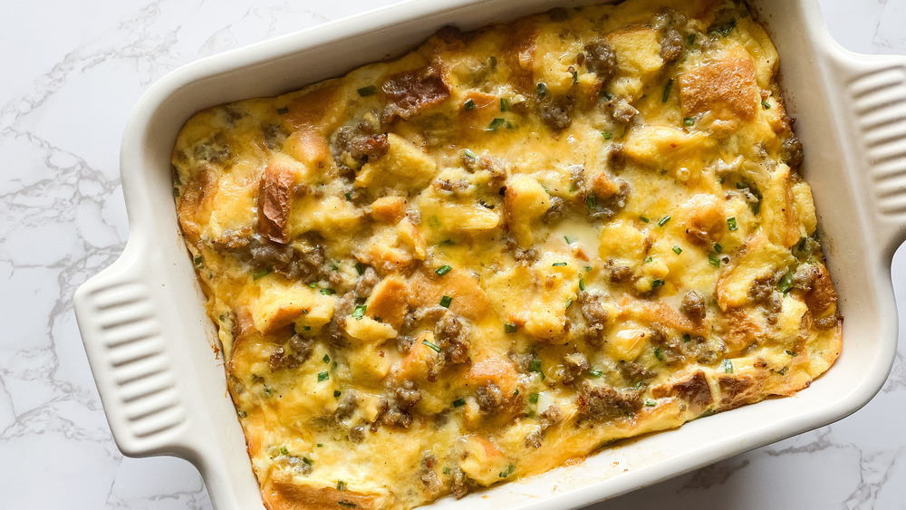 white casserole dish full of breakfast casserole sitting on a white counter