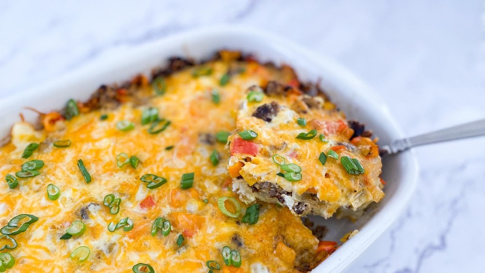 white casserole dish full of sausage breakfast casserole on a gray counter