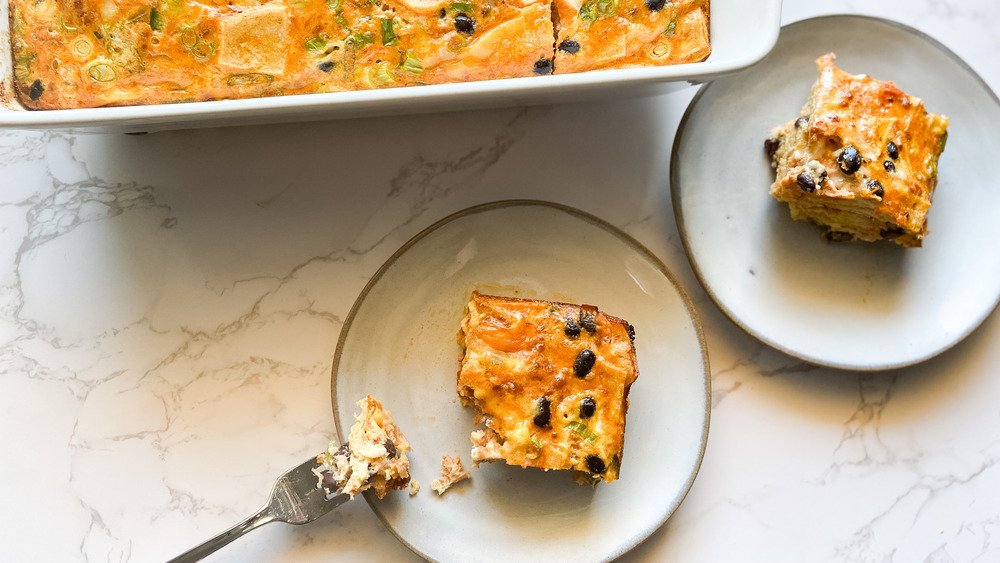 slices of breakfast casserole on a plate and in a baking dish on a counter