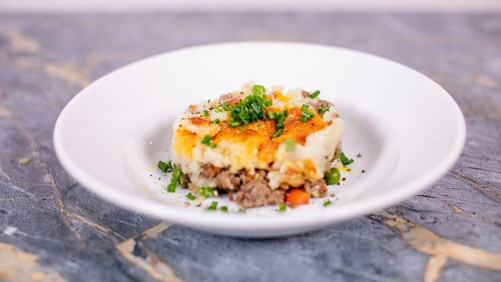 shepherd's pie on a white plate on a gray counter