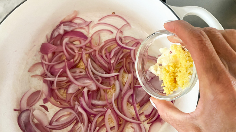 adding garlic, ginger to pot 