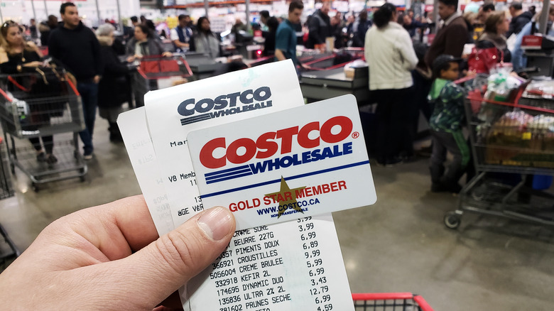 Customer holding Costco receipt