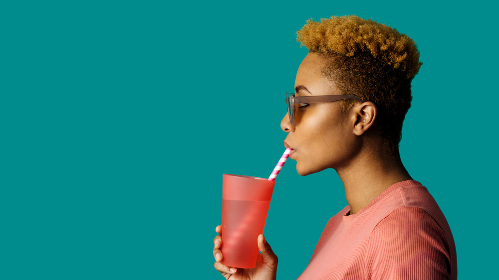 Woman drinking something from a straw