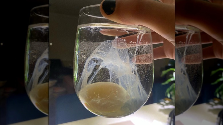 Raw egg in glass of water