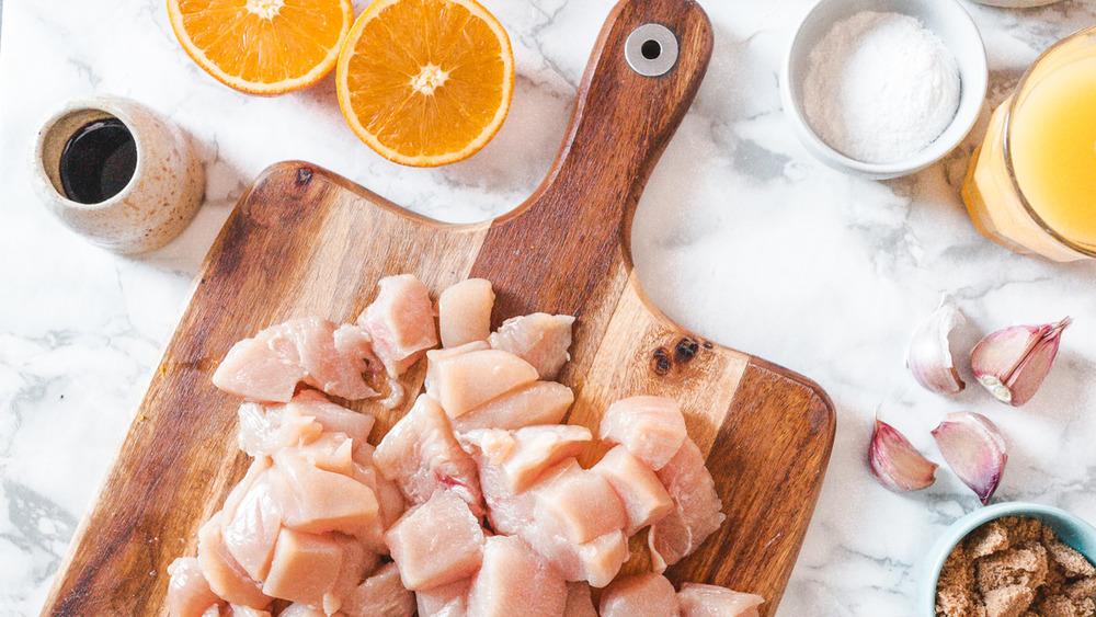 diced chicken on cutting board for orange chicken