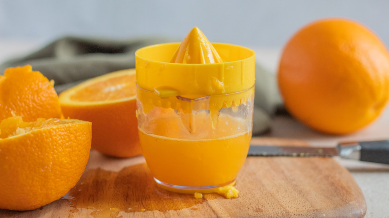 orange juicer with oranges