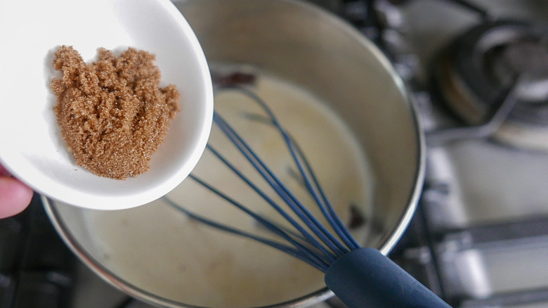 adding brown sugar to saucepan