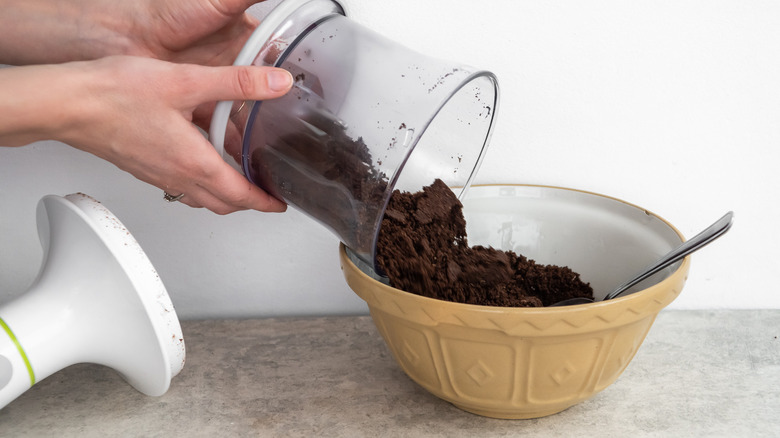 Oreo cookie crumbs pouring into bowl