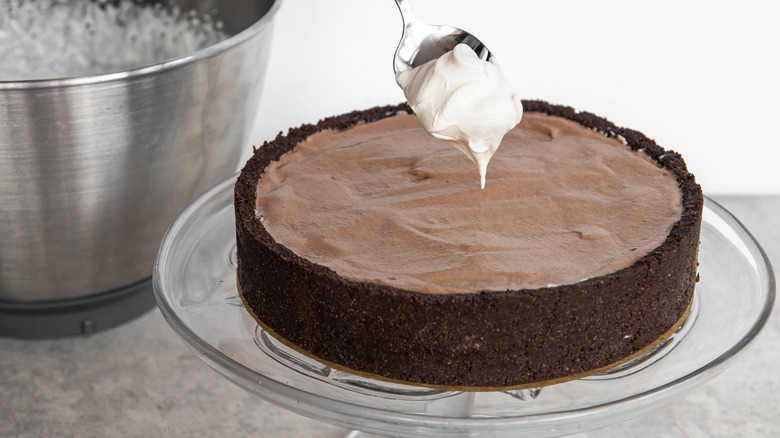 spoonful of whipped cream over Oreo pudding pie