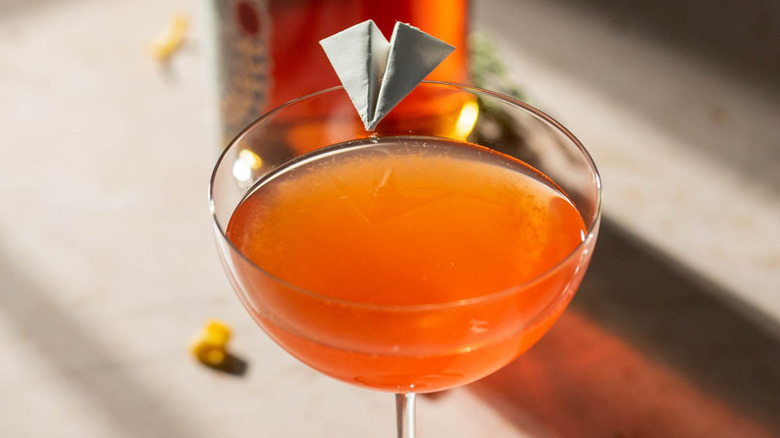 cocktail with paper plane garnish