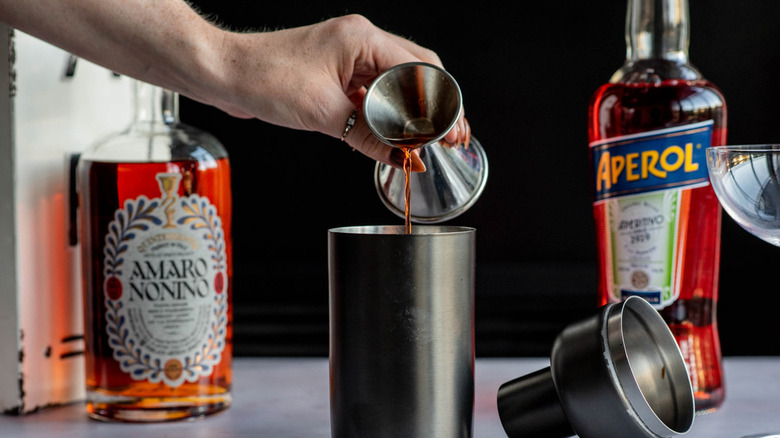 liquid pouring into cocktail shaker