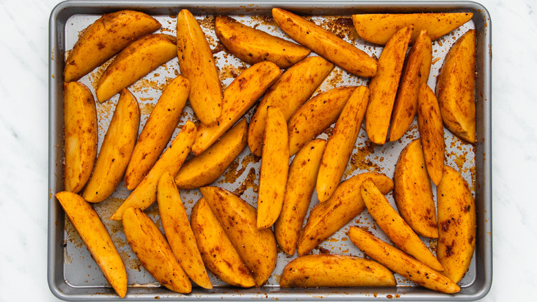 seasoned potato wedges on sheet