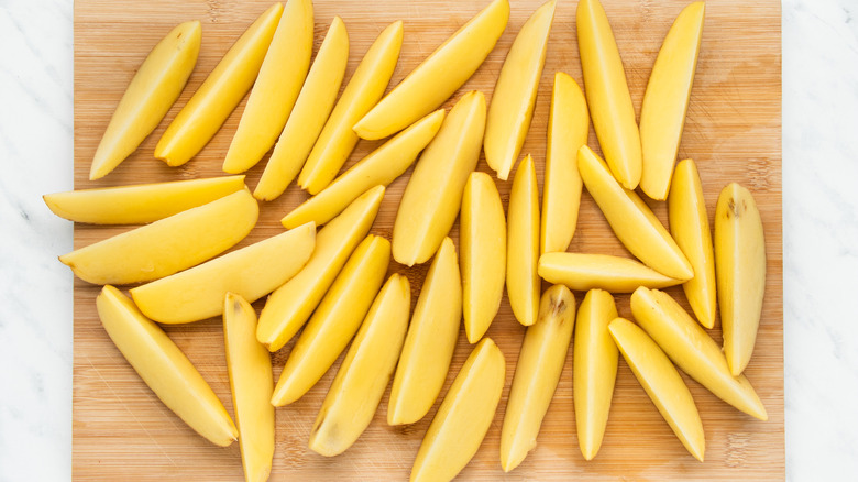 potato wedges on cutting board