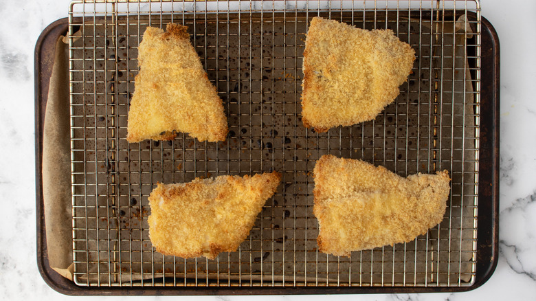 golden fried fish on rack