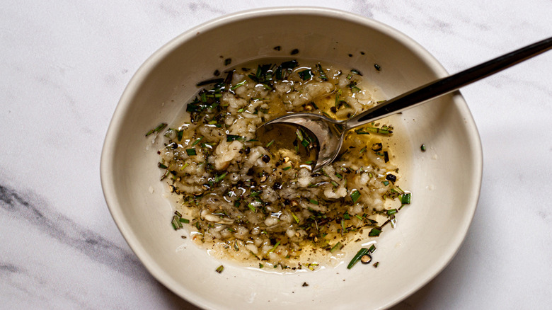 bowl of assorted seasonings in olive oil