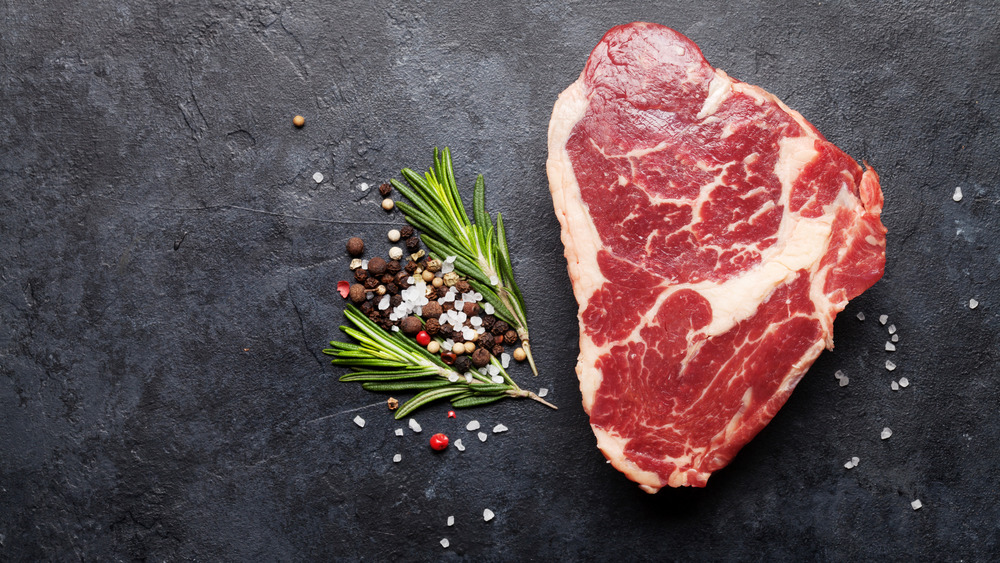 Ribeye steak placed on table