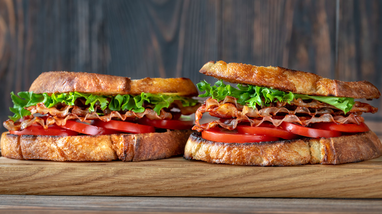 Two thick BLT sandwiches next to each other