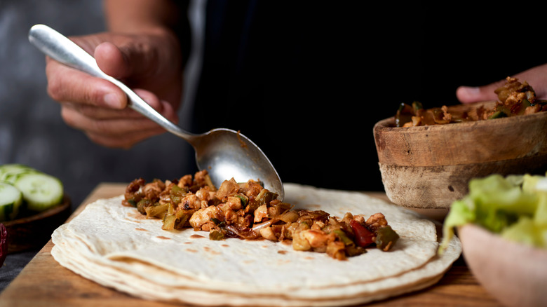 Man preparing a burrito