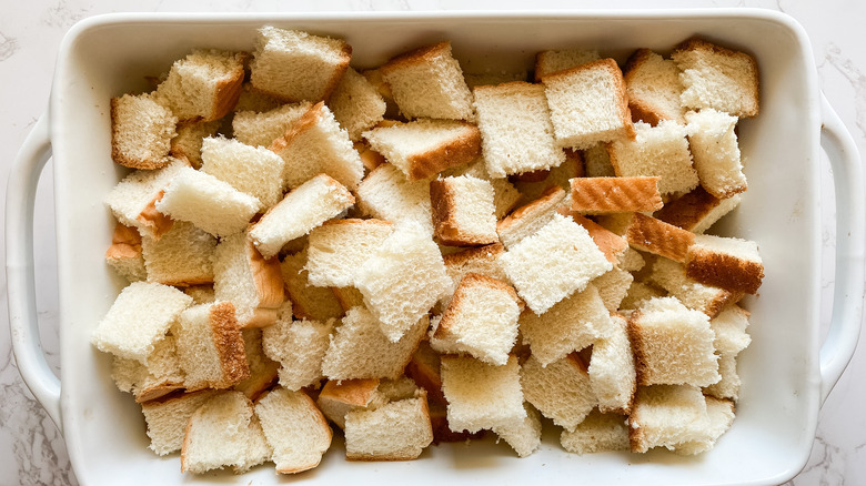 cubed bread in baking dish