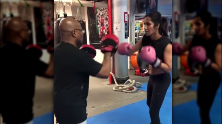 Padma Lakshmi boxing with pink boxing gloves