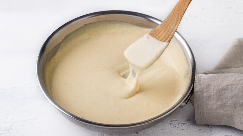 A thick creamy sauce in a pan