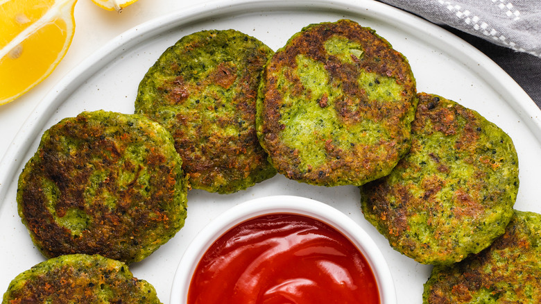 broccoli fritters on plate with ketchup