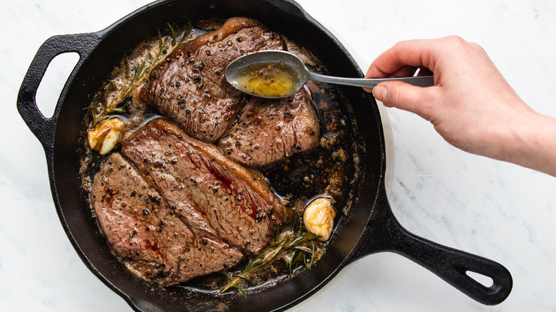 garlic rosemary steaks in skillet