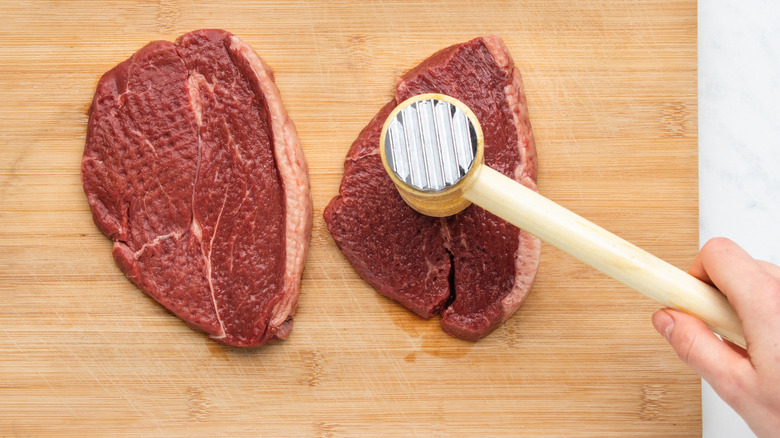 tenderizing steaks with meat mallet