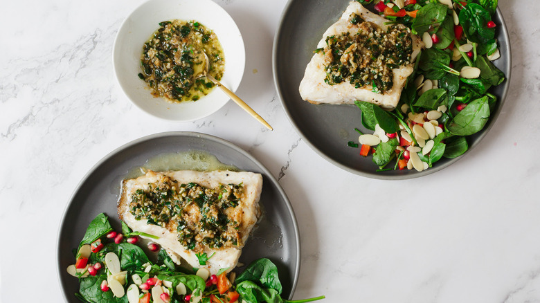 fish and salad on two plates