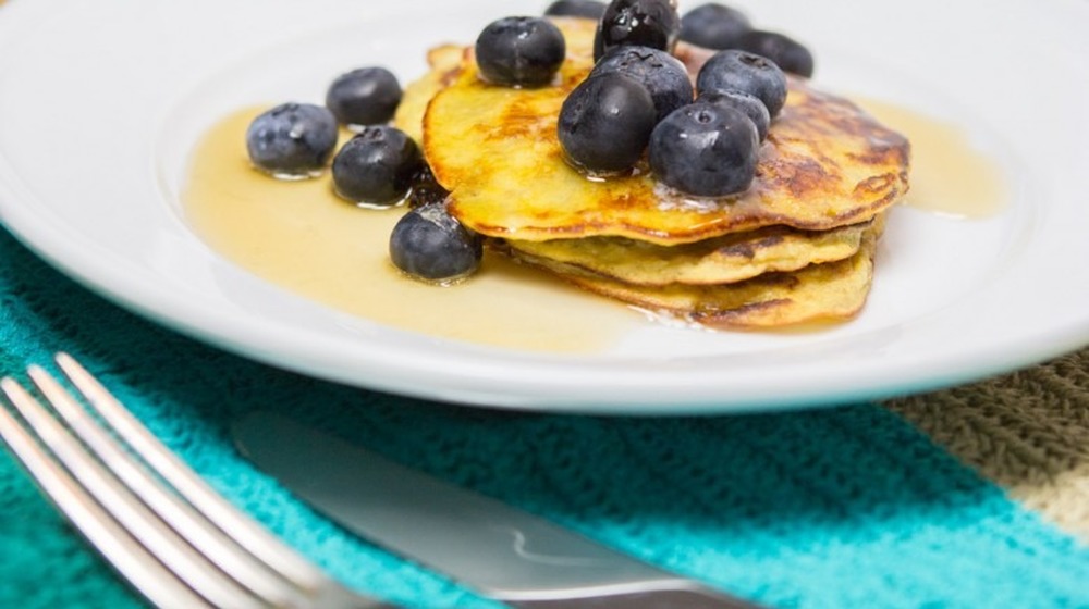 three pancakes topped with blueberries
