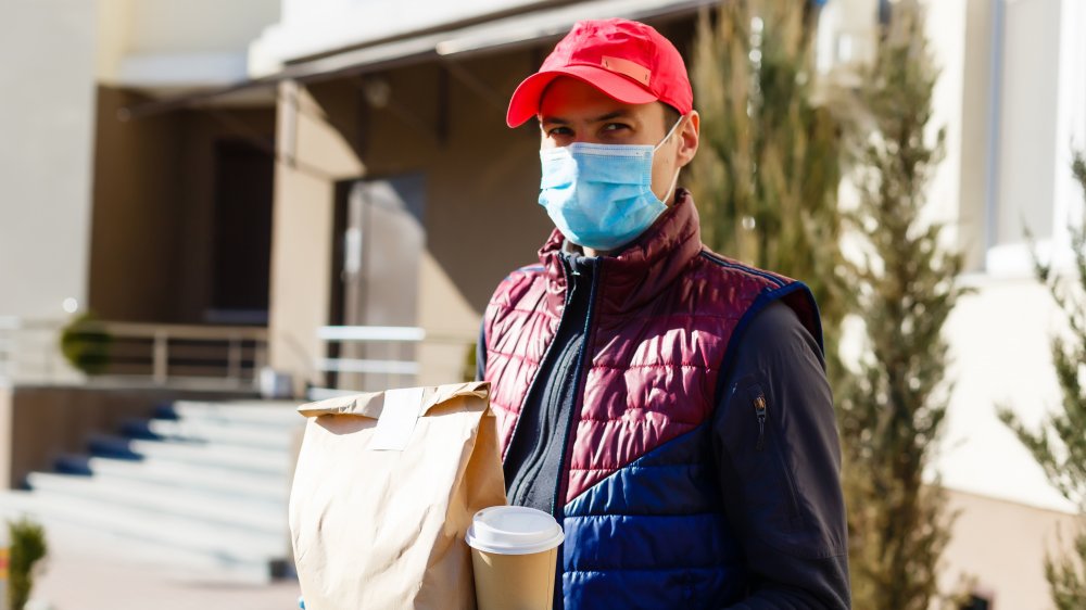 Delivery person with food and coffee