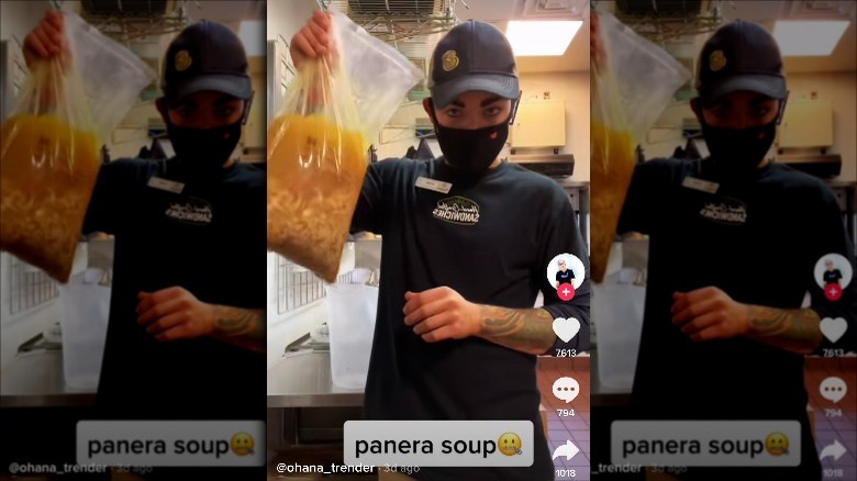 Panera employee holding soup bag