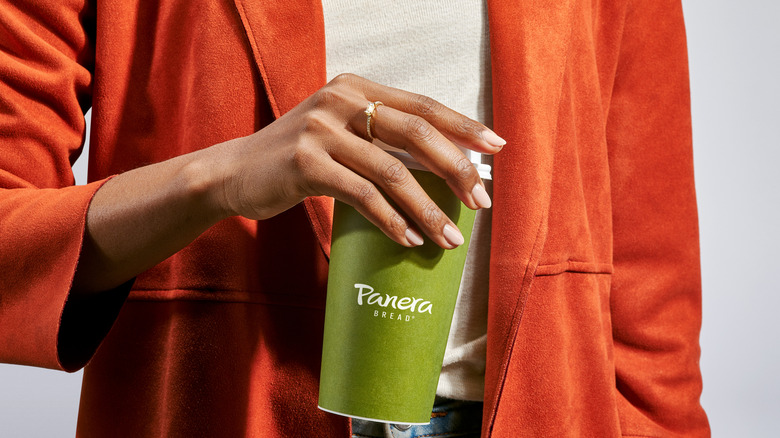 A woman with a cup of Panera coffee