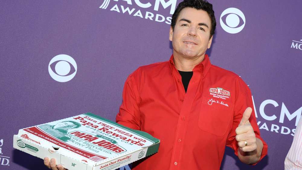 John Schnatter at an awards show with a pizza box