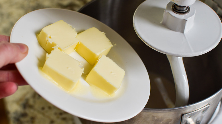 adding butter to the mixer