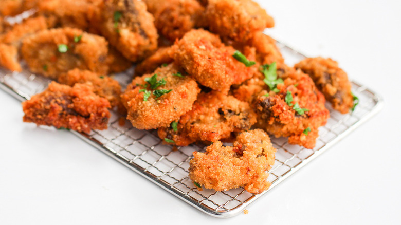 Fried, crispy mushrooms on skimmer