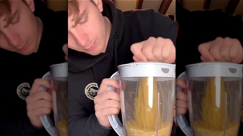 Man puts pasta in a blender