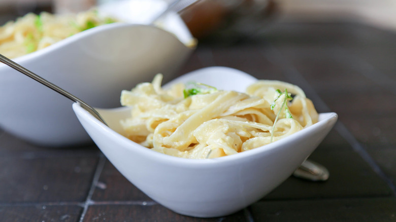 bowl overflowing with creamy fettucine Alfredo