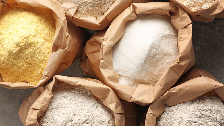 Different types of flour in brown paper bags