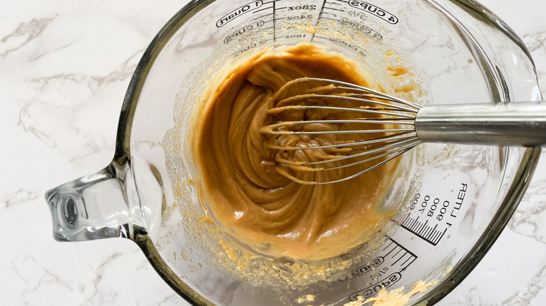 peanut sauce in measuring cup