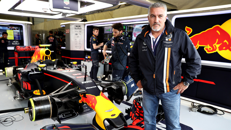 Paul Hollywood standing in front of a Formula 1 Red Bull race car