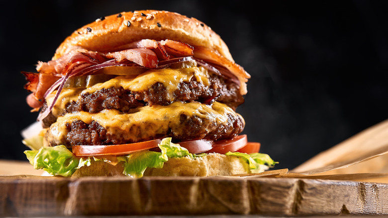 Juicy cheese burger on cutting board